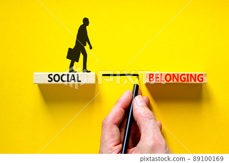 Social belonging symbol. Wooden blocks with concept words Social belonging on beautiful yellow background. Businessman icon. Businessman hand. Business political social belonging concept. Copy space. Social belonging symbol. Wooden blocks with concept words Social belonging on beautiful yellow background. Businessman icon. Businessman hand. Business political social belonging concept. Copy space. 89100169