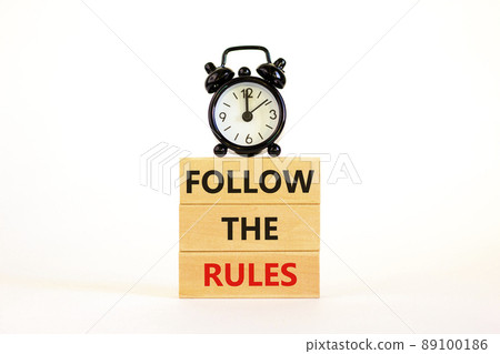 Follow the rules symbol. Concept words Follow the rules on wooden blocks. Beautiful white background. Black alarm clock. Business and follow the rules concept. Copy space. Follow the rules symbol. Concept words Follow the rules on wooden blocks. Beautiful white background. Black alarm clock. Business and follow the rules concept. Copy space. 89100186