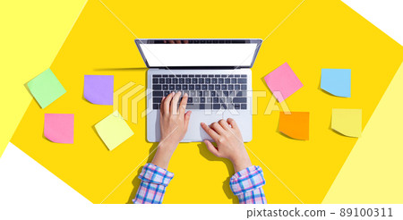 Laptop computer with many sticky notes Laptop computer with many sticky notes 89100311