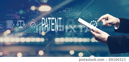 Patent concept with businessman using a tablet 89100321