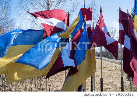 Flags of Ukraine and Latvia. Protest against war and global military conflict, invasion in Riga, Europe Flags of Ukraine and Latvia. Protest against war and global military conflict, invasion in Riga, Europe 89100358