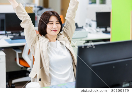 Young woman stretching in the office 89100579