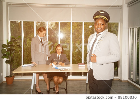A flight attendant poses in his own workplace. 89100830