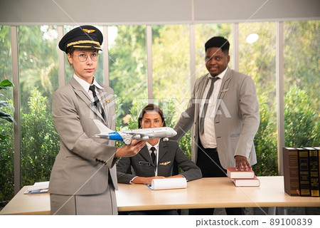 A flight attendant poses in her own workplace. A flight attendant poses in her own workplace. 89100839