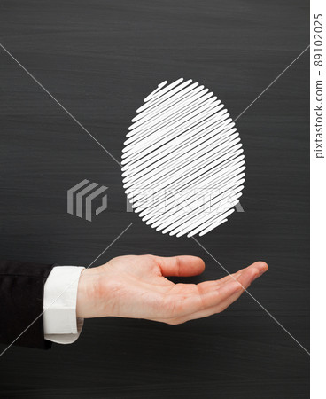hand holding chalk painted egg 89102025