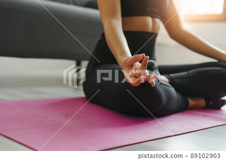Close up woman wearing sportswear yoga poses for beginner, Lotus pose ( Padmasana). Close up woman wearing sportswear yoga poses for beginner, Lotus pose ( Padmasana). 89102903