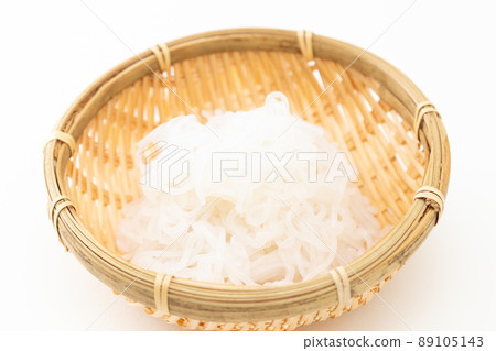 Shirataki noodles in a colander white background 89105143