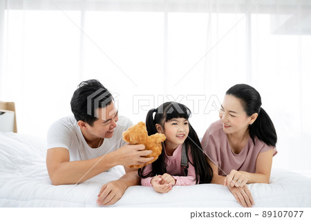 Happy asian family people leisure in bedroom together Happy asian family people leisure in bedroom together 89107077