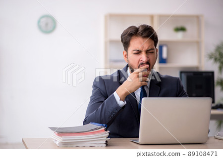 Young male employee working in the office Young male employee working in the office 89108471
