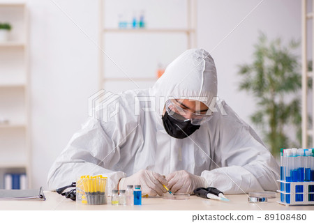 Young male chemist working at the lab during pandemic Young male chemist working at the lab during pandemic 89108480