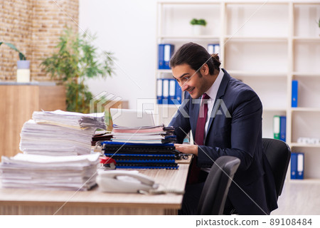 Young male employee unhappy with excessive work 89108484