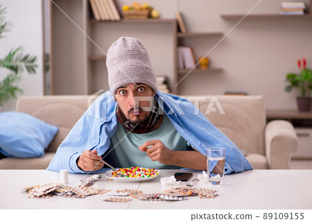 Young sick man suffering at home Young sick man suffering at home 89109155