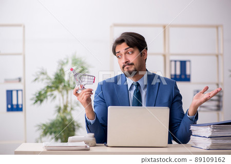 Young male employee in e-commerce concept Young male employee in e-commerce concept 89109162