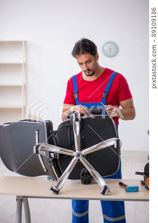 Young male repairman working at workshop Young male repairman working at workshop 89109186