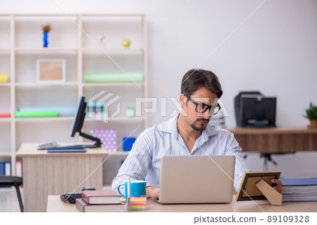 Young male employee missing wife at workplace Young male employee missing wife at workplace 89109328