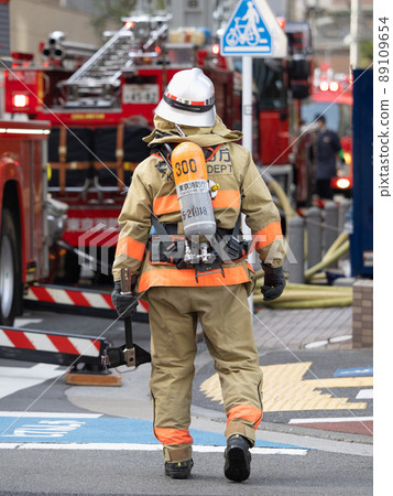 Firefighters in the process of extinguishing a fire Firefighters in the process of extinguishing a fire 89109654