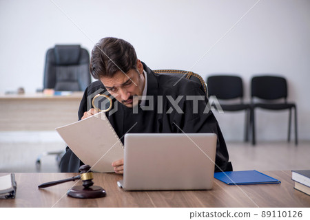 Young male judge working in the courthouse 89110126