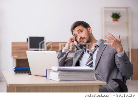 Young male employee working in the office Young male employee working in the office 89110129