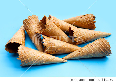Empty ice cream cone on blue background. Empty ice cream cone on blue background. 89110239
