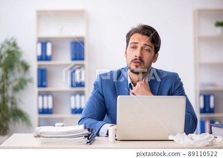 Young male employee suffering at workplace 89110522