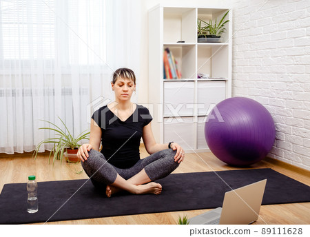 Young sporty woman practicing yoga. Mindfulness meditation concept.  89111628