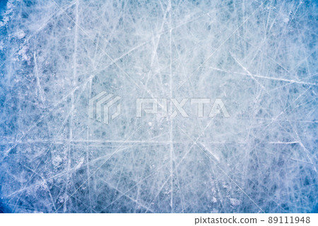 Ice background with marks from skating and hockey, blue texture of rink surface with scratches Ice background with marks from skating and hockey, blue texture of rink surface with scratches 89111948
