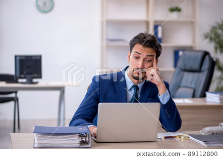 Young male employee working in the office 89112800