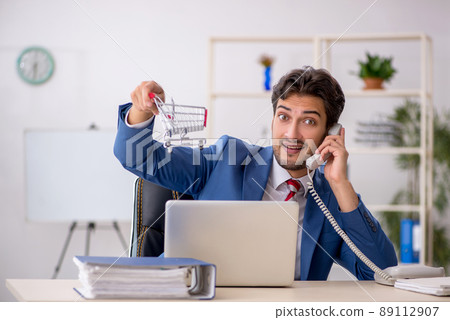 Young male employee in e-commerce concept 89112907