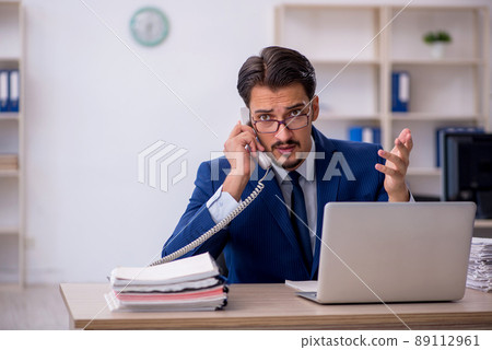 Young male employee working in the office Young male employee working in the office 89112961