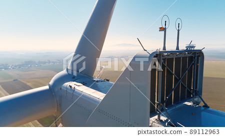 Aerial view of close up windmill turbine in countryside area, Wind power and renewable sustainable energy concept Aerial view of close up windmill turbine in countryside area, Wind power and renewable sustainable energy concept 89112963
