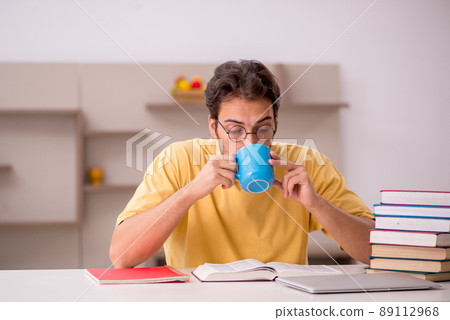 Young male student preparing for exams at home Young male student preparing for exams at home 89112968