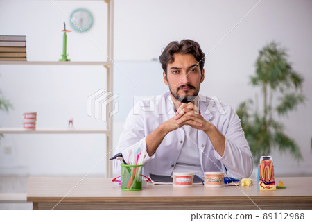 Young male dentist working in the clinic Young male dentist working in the clinic 89112988