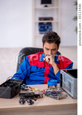 Young male repairman repairing computer 89113486