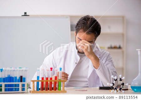 Young male chemist working at the lab 89113554