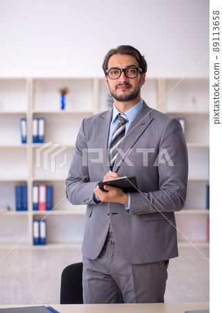 Young male employee working in the office 89113658