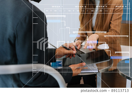 Project manager working and update tasks with milestones progress planning and Gantt chart scheduling diagram.business tram working at office. 89113713