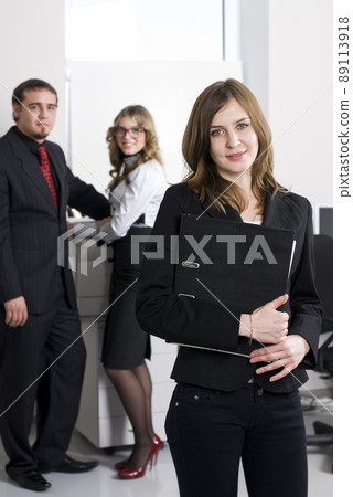 Smiling young businesswoman in office Smiling young businesswoman in office 89113918
