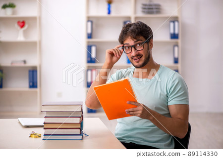 Young male student preparing for exams in the classroom Young male student preparing for exams in the classroom 89114330