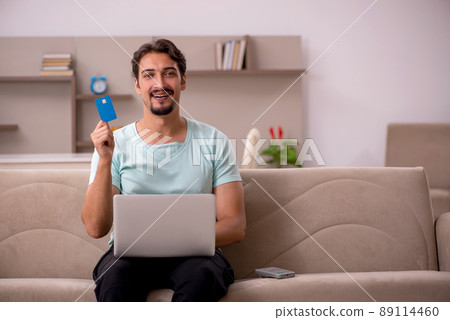Young male freelancer sitting on the sofa 89114460