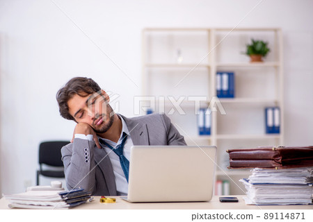 Young male employee in oversleeping concept 89114871