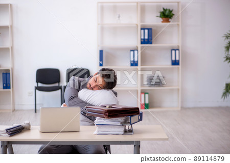 Young male employee in oversleeping concept Young male employee in oversleeping concept 89114879