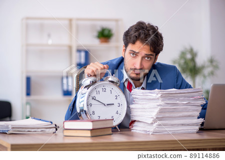 Young male employee in time management concept 89114886