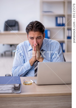 Young male employee working in the office Young male employee working in the office 89115578