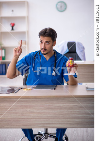Young male doctor cardiologist working in the clinic 89115611