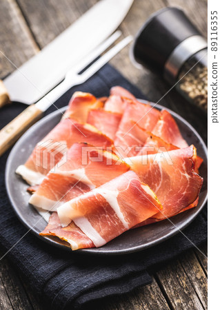 Sliced schwarzwald ham. Dried prosciutto ham on plate. Sliced schwarzwald ham. Dried prosciutto ham on plate. 89116355