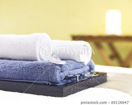 rolled towels on a tray on massage bed in beauty spa or health club 89116647