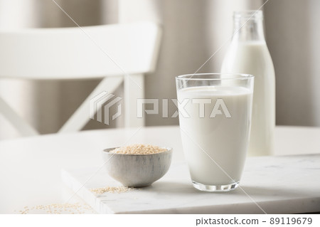 Sesame milk on white kitchen background. Lactose free. Close up. Lack of cholesterol. 89119679