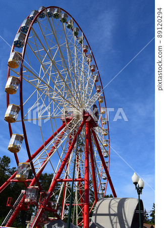 Ferris wheel against the blue sky Ferris wheel against the blue sky 89120294