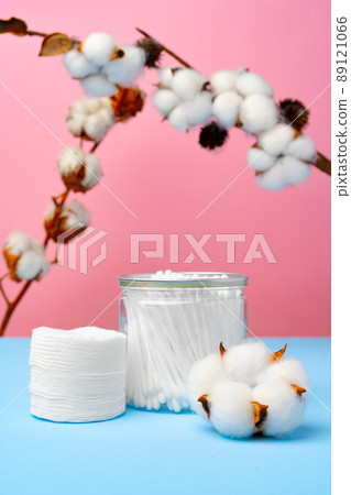 Cotton buds for cleaning ears on pink and blue background Cotton buds for cleaning ears on pink and blue background 89121066