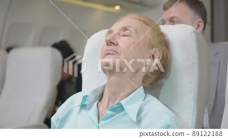 elderly with blanket during trip on the airplane elderly with blanket during trip on the airplane 89122188